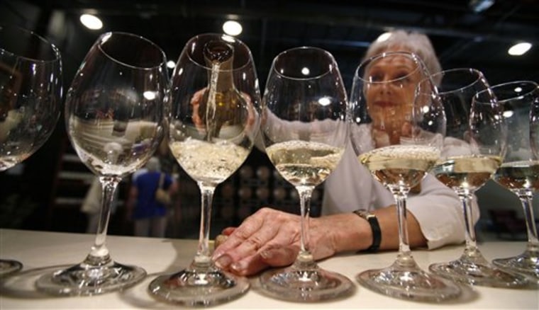Elizabeth Richardson pours wine for a tour group at the Chateau Ste. Michelle winery in Woodinville, Wash. 